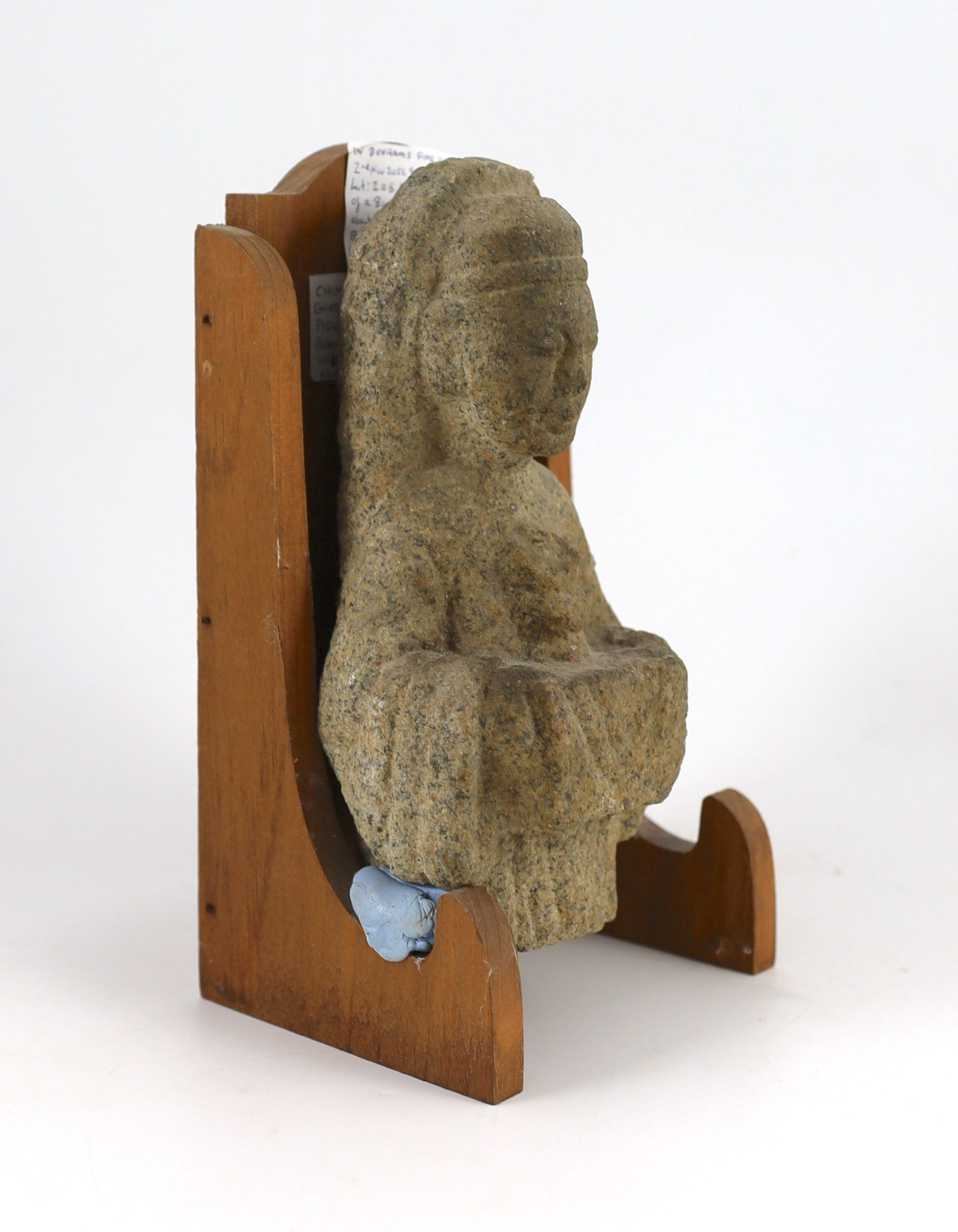 A Chinese granite fragment of a Buddhist offering figure, probably Northern Wei dynasty, 22.5cm, later stand